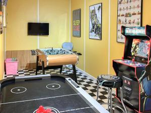 a room with a game room with a table and a video game at Seapoint House in Cleveleys