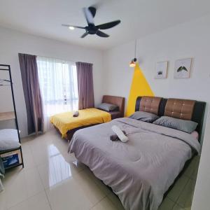 a bedroom with two beds and a ceiling fan at B3 Superb PoolView Manhattan Waterpark Homestay Ipoh4-8Pax NETFLIX in Ipoh