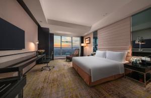 a hotel room with a bed and a flat screen tv at Holiday Inn Beijing Focus Square by IHG in Beijing +110 photos