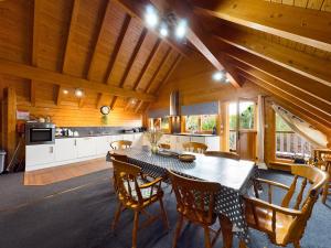 a kitchen and dining room with a table and chairs at Alpine Lodge in Pentney