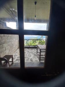 a view of a window with a bench through it at Aroma Holiday Home-Haputhale in Haputale