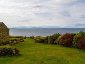 an old house on the coast of the ocean at Fishermans Cove - W42425 in Pierowall