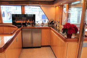 a kitchen with a bar with a sink and a fireplace at All Of Me Yacht in Richmond