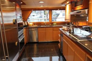 a kitchen in an rv with a sink and a stove at All Of Me Yacht in Richmond