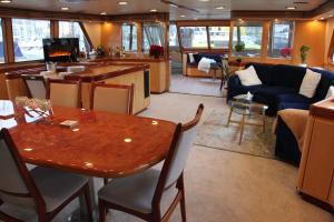 a dining room and living room on a cruise ship at All Of Me Yacht in Richmond