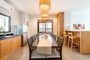 a kitchen and dining room with a table and chairs at Portrait Huahin in Hua Hin