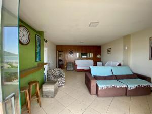 a hotel room with a bed and a clock at Apartamento com Vista in Balneário Camboriú