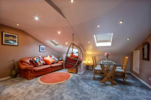 a living room with a couch and a table at Premium 2nd floor 2 bed Apt sleeps 4 adults in Oban town in Oban
