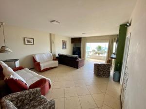 a living room with a couch and chairs in it at Apartamento com Vista in Balneário Camboriú