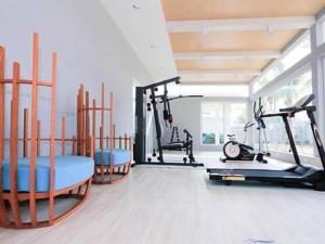 a gym with two exercise bikes and a treadmill at The Sea Condominium in Sam Roi Yot