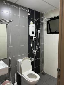 a bathroom with a toilet and a shower in it at TheSevenBahrin Homestay in Seri Kembangan