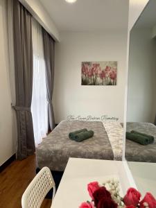 a hotel room with two beds and a mirror at TheSevenBahrin Homestay in Seri Kembangan