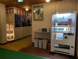 a room with a refrigerator with drinks in it at Hotel Suehiro in Matsumoto