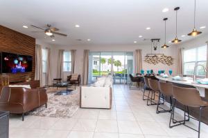 a living room with a table and chairs at Luxurious 5Bd Private Pool Jacuzzi & Game Room at Encore 7432 in Orlando