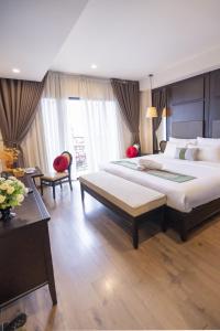 a large bedroom with a large bed and a desk at Hanoi Center Silk Charming Hotel & Travel in Hanoi