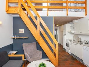 a loft apartment with a staircase and a living room at 6 person holiday home in Fan in Fanø