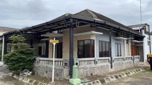 a small house with a sign in front of it at Royal Stay@Yogyakarta in Kalasan