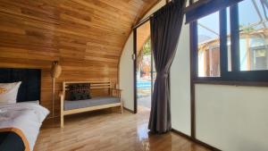 a bedroom with a bed and a large window at Ha Giang Loop Hostel & Tours in Ha Giang