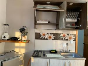 a small kitchen with a sink and a stove at Janeth’s Place Apartamento in San Andrés