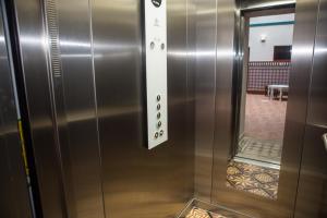 a metal elevator with a door in a room at Vivian's Guest House Auto Check-in in Jerez de la Frontera