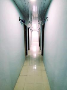 a long hallway with a long corridor with lights on the ceiling at Homestay 81 Batu Batam in Nagoya