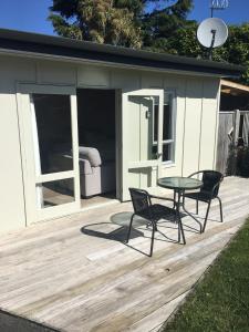 a patio with a table and chairs on a deck at Cosy Studio on Hyde in Taupo