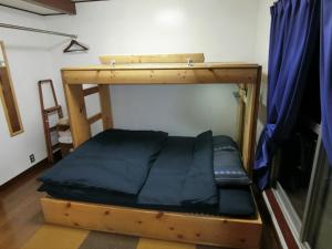 a bed in a room with a bunk bed at Shirokuma Inn in Toyama