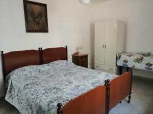 a bedroom with a bed and a table and a cabinet at Il Giardino della Nonna in Alberobello