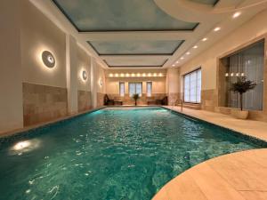 a pool in a hotel room with a large swimming pool at Luxury Villa Pool and Spa in Magdalenka