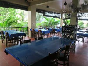 a dining room with blue tables and chairs at River Dolphin Hotel in Kratie