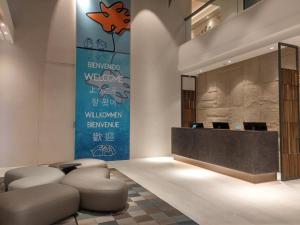a lobby with a reception desk and stools at AQUA Tree Resort in Fengbin