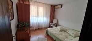 a small bedroom with a bed and a window at Casa Lazăr in Braşov +7 photos