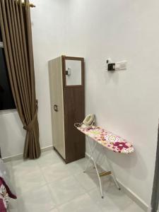 a room with a table with a phone and a door at JRK HOMESTAY A in Jertih