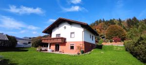 a small house in a yard with a green field at Pinball apartment in Feldkirchen in Kärnten