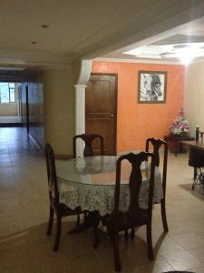 a dining room with a table and four chairs at Hotel El Parque HR in Fómeque