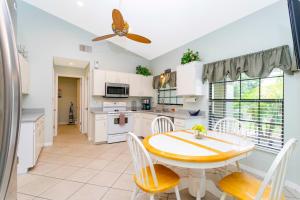 a kitchen with a table and chairs and a ceiling fan at Charming 3Bd w/ Pool Close to Disney @ 7826 Indian Ridge in Orlando