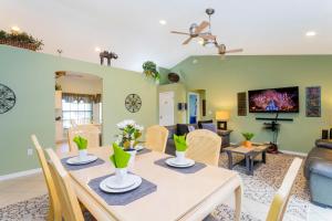 a dining room and living room with a table and chairs at Charming 3Bd w/ Pool Close to Disney @ 7826 Indian Ridge in Orlando