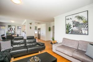 sala de estar con sofá y mesa en CHILLAX HOUSE - Luxury, Canals, Jetty, Family Friendly - Sleeps 14 in Style! en Mandurah