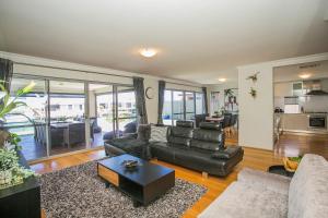 a living room with a couch and a table at CHILLAX HOUSE - Luxury, Canals, Jetty, Family Friendly - Sleeps 14 in Style! in Mandurah