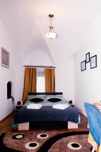 a bedroom with a bed with a blue comforter at Studio Leena in Sibiu