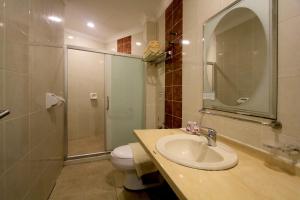 a bathroom with a sink and a toilet and a shower at Hotel Ming Star in Kuala Terengganu +19 photos