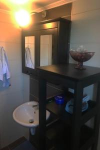 a bathroom with a sink and a counter with a mirror at Guedin Sea Side Maisonette, Nikiti in Nikiti