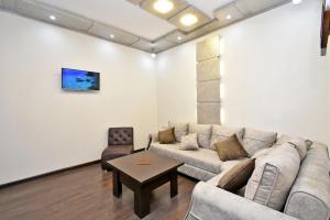 a living room with a couch and a table at Apart House in Yerevan Mashtots Avenue in Yerevan