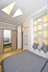 a bedroom with a bed and a large window at Apart House in Yerevan Mashtots Avenue in Yerevan