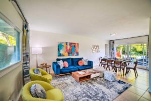 a living room with a blue couch and a table at Spacious Riverside Home with Game Room and Yard in Riverside