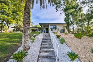 a house with a palm tree and a walkway at Spacious Riverside Home with Game Room and Yard in Riverside