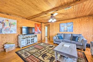 a living room with a couch and a table at Pet-Friendly Cabin Rental Retreat! 