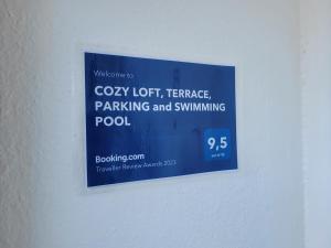 a sign on a wall that readsphony idiot teenager parking and swimming pool at "COZY LOFT", TERRACE, PARKING and SWIMMING POOL in Málaga