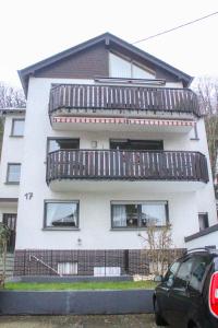a white building with a balcony on top of it at Ferienhaus Seilerbahn 17 in Vallendar