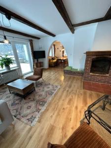 a living room with a fireplace and a living room with a couch at Stilvolle Familienwohnung in Wörnsmühl in Fischbachau